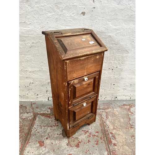 76 - A pine cabinet with hinged lid and two fall front cupboard doors