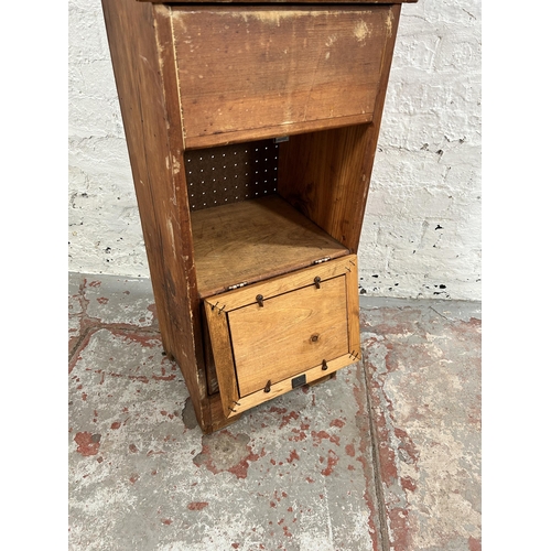 76 - A pine cabinet with hinged lid and two fall front cupboard doors