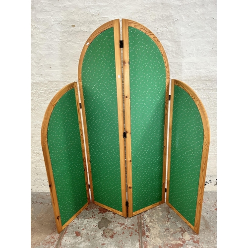 125 - A late 20th century pine and green fabric four section folding dressing screen
