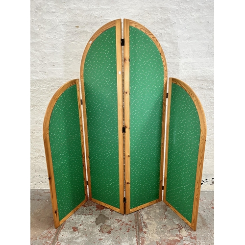 125 - A late 20th century pine and green fabric four section folding dressing screen