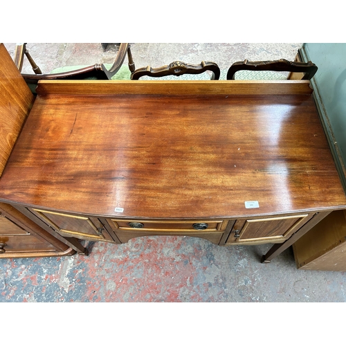 132 - An Edwardian mahogany bow fronted dressing table with single drawer, two outer cupboard doors and ta... 