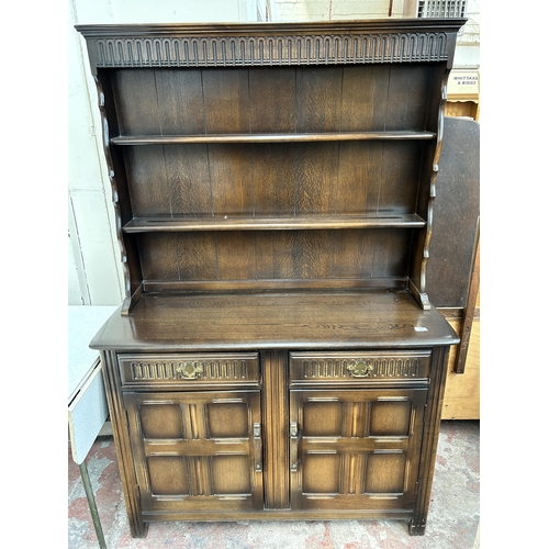 152 - An oak Welsh dresser with two drawers, two cupboard doors and upper plate rack