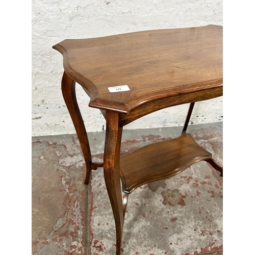 223 - An Edwardian walnut serpentine two tier side table