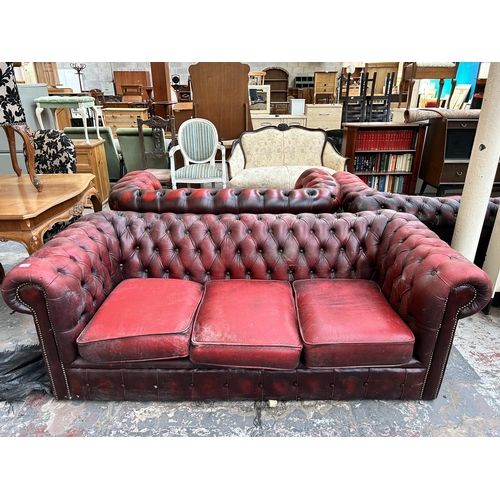 239 - An oxblood leather Chesterfield three seater sofa