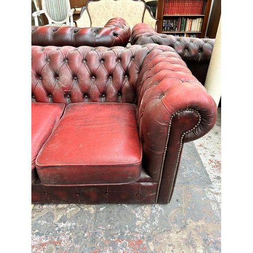 239 - An oxblood leather Chesterfield three seater sofa