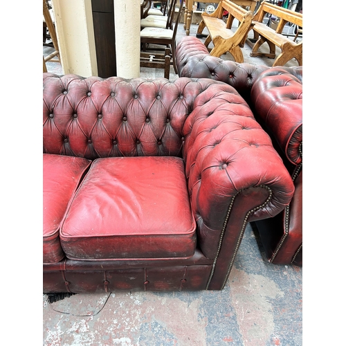 240 - An oxblood leather Chesterfield three seater sofa