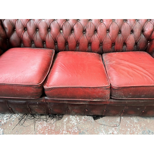 240 - An oxblood leather Chesterfield three seater sofa