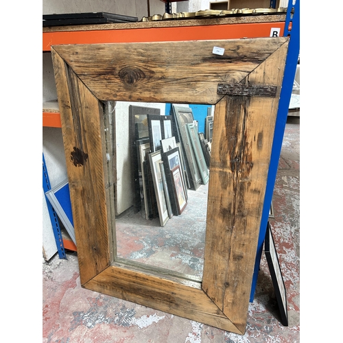 275 - A vintage rustic pine framed wall mirror - approx. 93cm high x 130cm wide