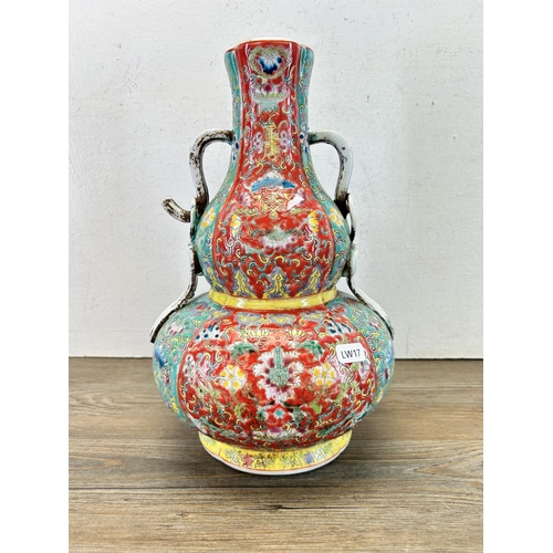 313 - A Chinese Famille Rose twin handled vase - approx. 32cm high