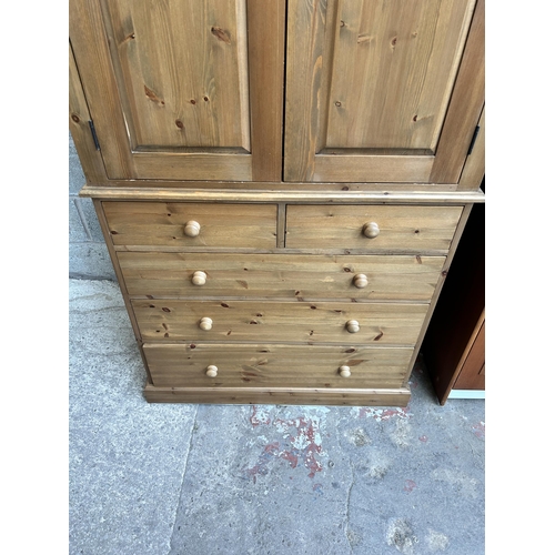 1 - A Victorian style pine larder cupboard with two doors, two upper shelves, two short drawers and thre... 