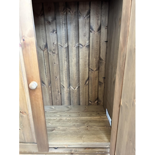 1 - A Victorian style pine larder cupboard with two doors, two upper shelves, two short drawers and thre... 
