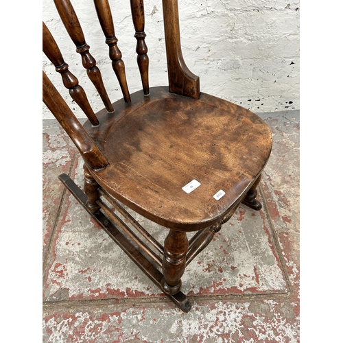 25 - A Victorian beech spindle back farmhouse rocking chair