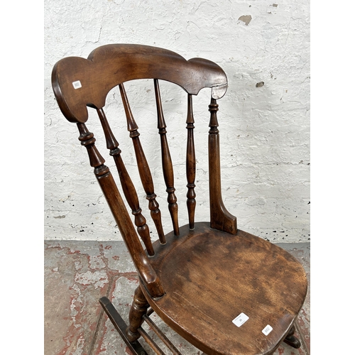 25 - A Victorian beech spindle back farmhouse rocking chair