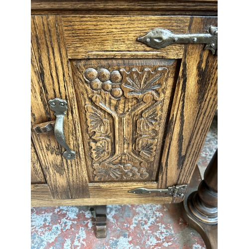 33 - A Webber Furniture carved oak dresser with four upper leaded glass doors, four cupboard doors and fo... 