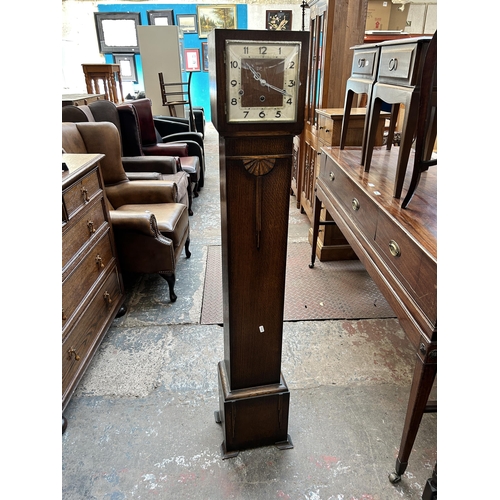 39 - A 1930s oak cased Westminster chime grandmother clock with pendulum - approx. 142cm high