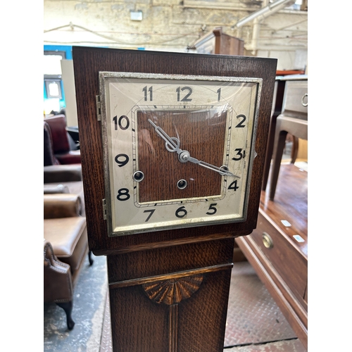39 - A 1930s oak cased Westminster chime grandmother clock with pendulum - approx. 142cm high