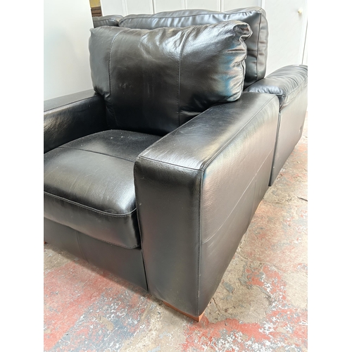 49 - A modern black leatherette armchair