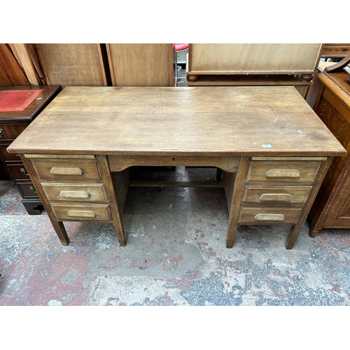 56 - A mid 20th century oak twin pedestal office desk with five drawers - approx. 77cm high x 152cm wide ... 