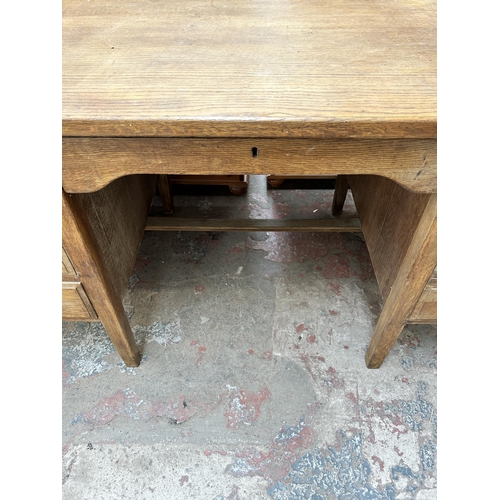 56 - A mid 20th century oak twin pedestal office desk with five drawers - approx. 77cm high x 152cm wide ... 