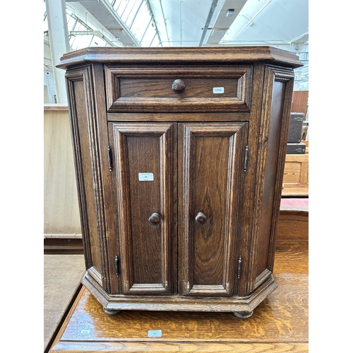 58 - An oak side cabinet with two cupboard doors and single drawer
