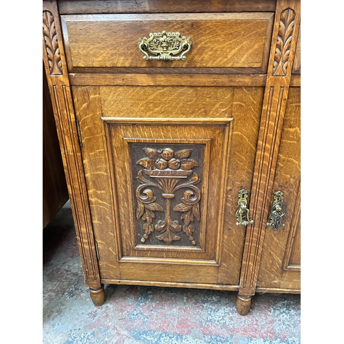 59 - A late Victorian/Edwardian carved oak sideboard with galleried back, three drawers and three cupboar... 