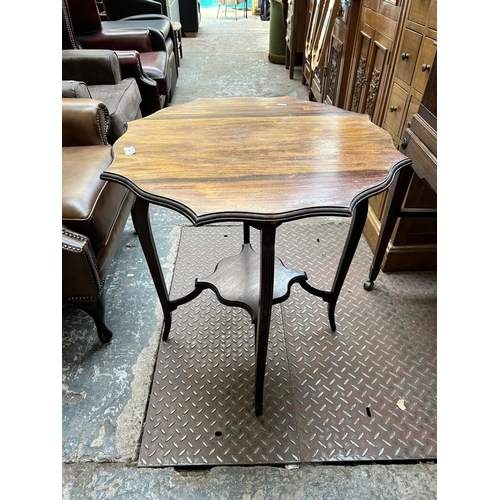 64 - An Edwardian mahogany serpentine two tier occasional table