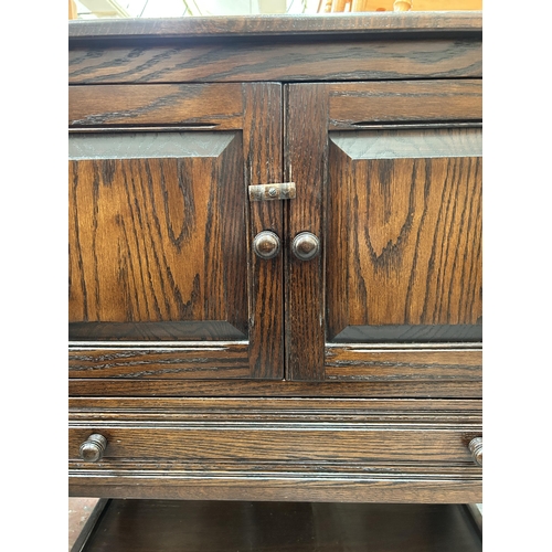 67 - An oak side cabinet with two cupboard doors and single drawer