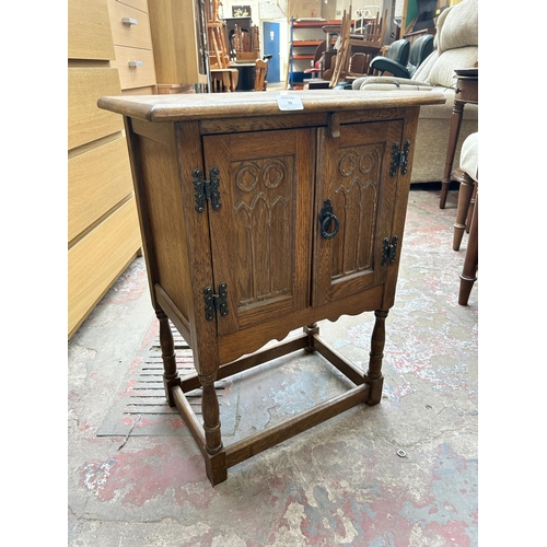 79 - A 17th century style carved oak two door side cabinet