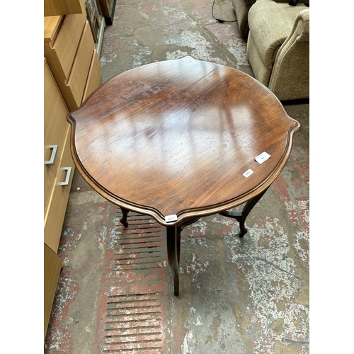 82 - An Edwardian walnut serpentine two tier side table