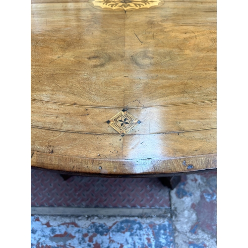 90 - A Victorian inlaid walnut oval loo table on quatrefoil base