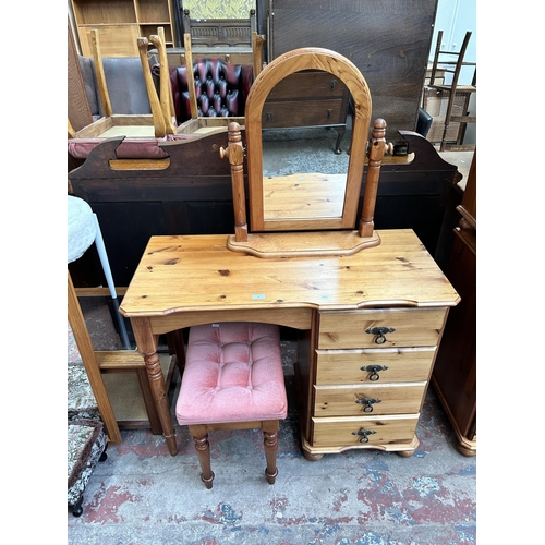92 - A pine dressing table with four drawers, stool and mirror