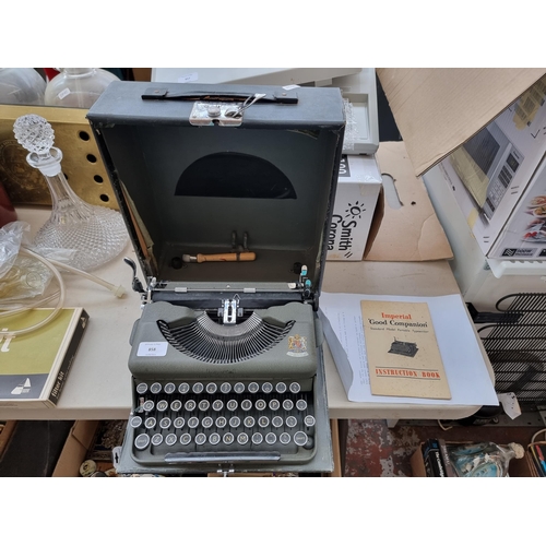 858 - A cased vintage Imperial Good Companion portable typewriter with instruction book