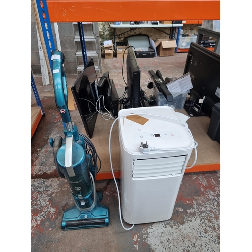 869 - Two items, one Hoover H-Upright 500 bagless vacuum cleaner and one Challenge air conditioner