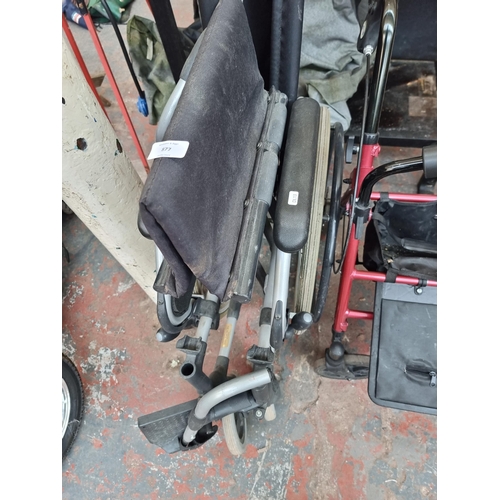 877 - Three mobility items, one Sunrise medical folding wheelchair, one Drive four wheeled walking frame a... 