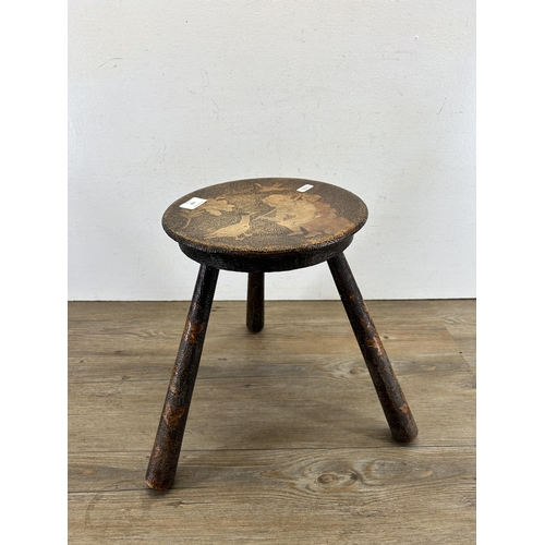 102 - A late 19th/early 20th century pokerwork three legged milking stool - approx. 35cm high x 25cm diame... 
