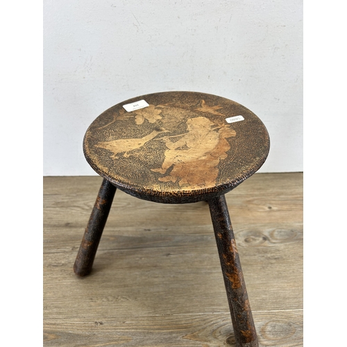 102 - A late 19th/early 20th century pokerwork three legged milking stool - approx. 35cm high x 25cm diame... 
