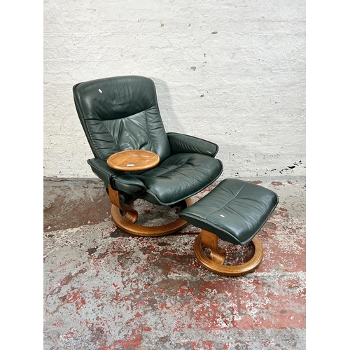 108 - An Ekornes Stressless green leather and bentwood reclining armchair with revolving side table and fo... 