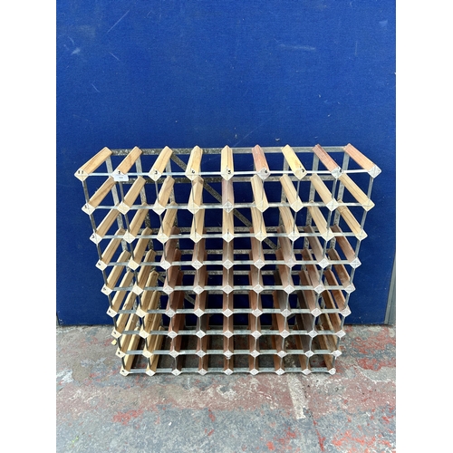 113 - A wood and metal sixty four section bottle rack