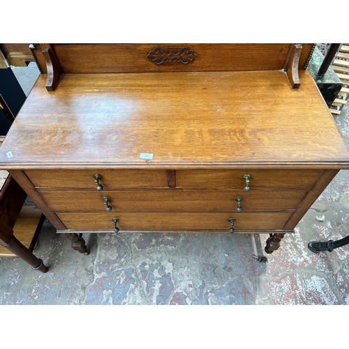 114 - An early 20th century oak dressing table with upper oval bevelled edge mirror, two short drawers, tw... 