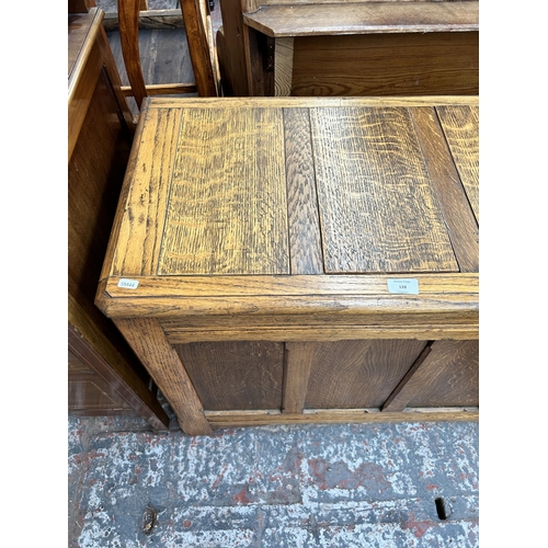 128 - An early/mid 20th century oak four panel blanket box with fitted interior