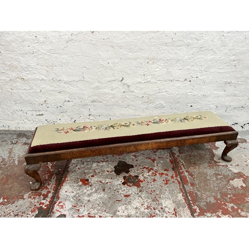131 - An Edwardian walnut and tapestry upholstered footstool with cabriole supports