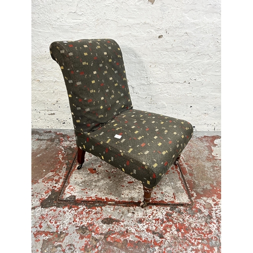 141 - A Victorian fabric upholstered bedroom chair with turned mahogany supports and castors