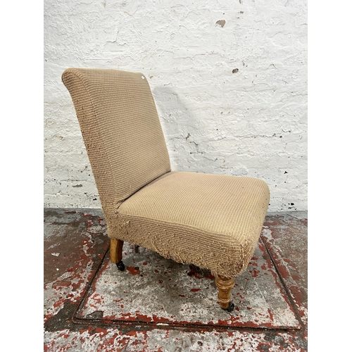 142 - A Victorian fabric upholstered bedroom chair with turned beech supports and castors