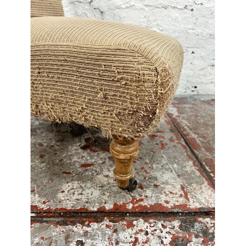 142 - A Victorian fabric upholstered bedroom chair with turned beech supports and castors