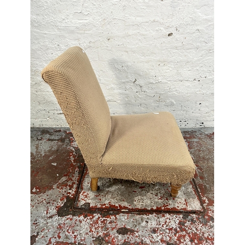 142 - A Victorian fabric upholstered bedroom chair with turned beech supports and castors