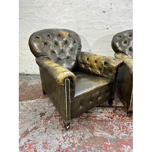 145 - A pair of early 20th century green leather club armchairs with mahogany supports