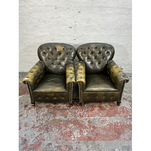 145 - A pair of early 20th century green leather club armchairs with mahogany supports