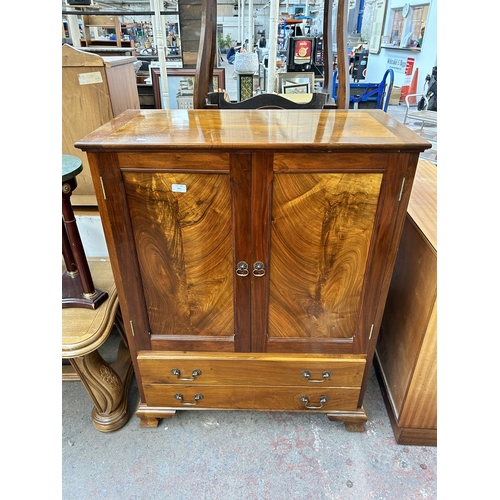 150 - A walnut two door cabinet with two lower drawers
