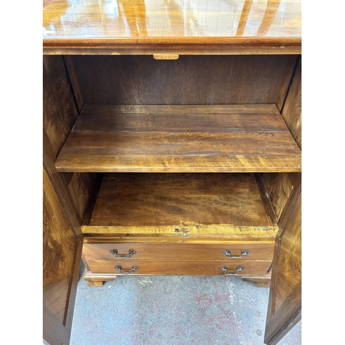 150 - A walnut two door cabinet with two lower drawers