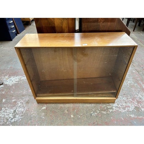160 - A mid 20th century teak bookcase with two glass sliding doors